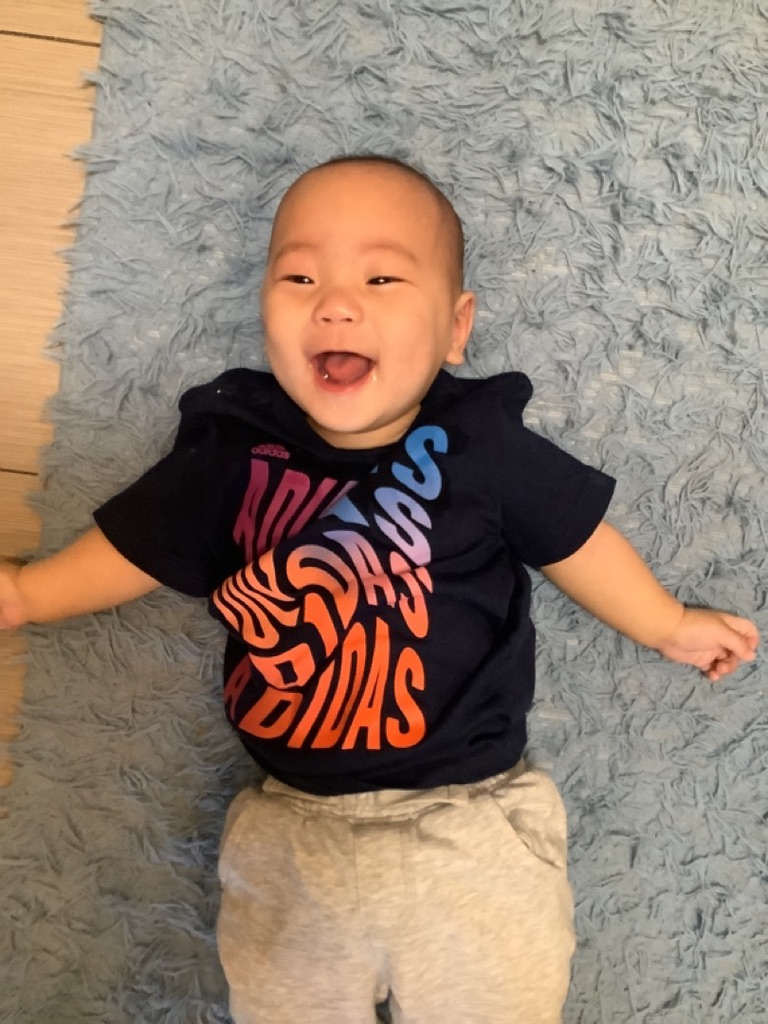 DE8B7A54-3969-4B36-9352-C6562D3B541D_1_105_c A giggling infant laying on his back at our preschool