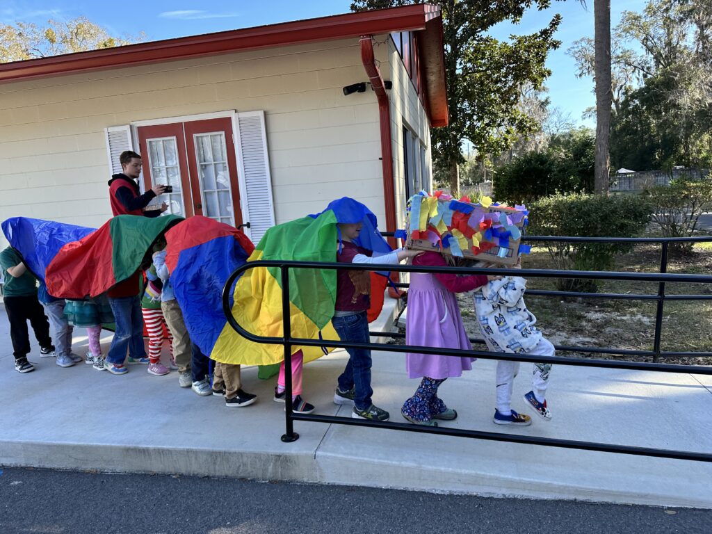IMG_7944 A group of four year olds pretending to be a Dragon outside while celebrating the Chinese New Year